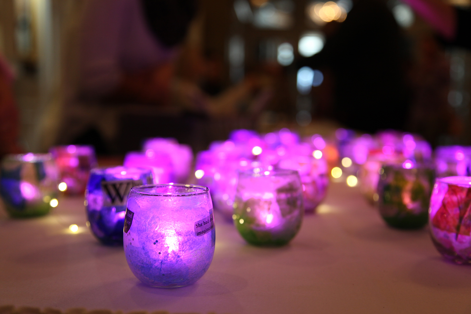 Purple candles sit on a table.
