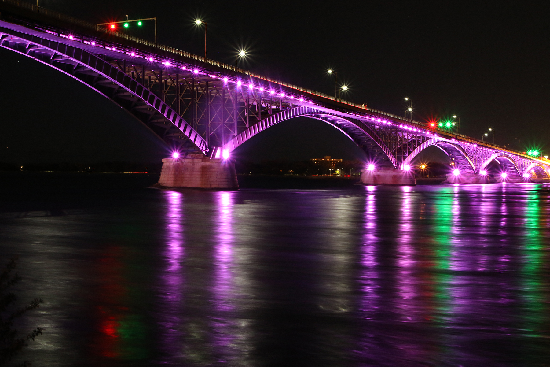 The Peace Bridge at night with purple lighting