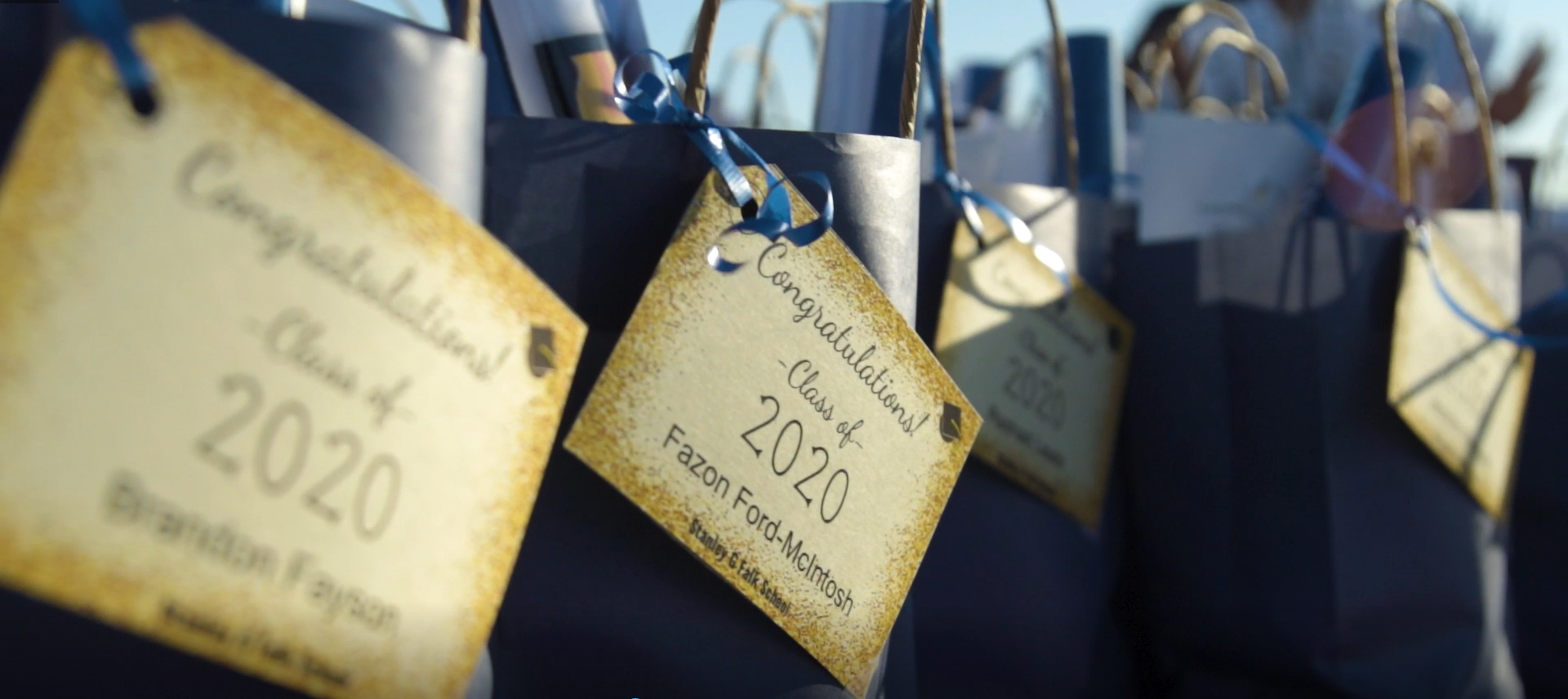 Blue gift bags with gold tags congratulating the students of the Class of 2020